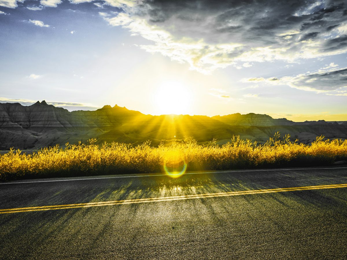 12. Sun bursting over an open asphalt road. The 'ray of hope'.